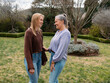 © Austockphoto - Mum and teenage daughter stands closely in the backyard looking at each other