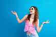 © deagreez - Young woman in pink top and sunglasses smiling joyfully against bright blue background — summer fashion, carefree lifestyle, colorful accessories and youthful portrait