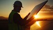 © Sirichat. Camphol - Solar panel installation renewable energy site action shot sunset environment worker viewpoint sustainable energy concept