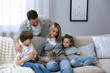 © New Africa - Happy family with their cute cat at home. Adorable pet