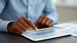 © Kateryna Arkhypova - Close-up of a businessman's hand touching a digital tablet to check pay-per-click traffic research, online business and marketing concept, with copy space