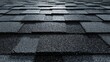 © ART BY SAIFUL - Close-up detail of new dark gray asphalt shingles on a residential roof surface.