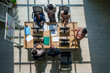 © Jirakul - Business team meeting office collaboration strategy marketing model ai planning fuels success as adult coworker applaud around desk with computer overhead view in daylight modern workspace