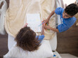 © .shock - Children drawing together in a Middle Eastern hospital bed while receiving pediatric care and support