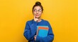 © Nina - Thoughtful young female student holding notebooks against a yellow background