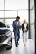 © dsheremeta - Salesman consulting woman customer buying new car