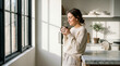 © Vishwesh - Mother's Day morning of self-care featuring a peaceful young woman enjoying coffee in a minimalist kitchen with natural sunlight