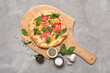 © Pixel-Shot - Wooden board with tasty tomato galette with fresh basil and spices on grunge background