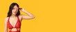 © Pixel-Shot - Beautiful young Asian woman in sexy lingerie holding flower on yellow background with space for text. International Women's Day
