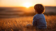 © Nataliya - Rear view of a child alone in a field at sunset looking at the horizon, dreamlike childhood concept, wonder and imagination, world children's day, defocused background, with copy space