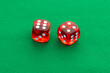 © Pamela Uyttendaele - Time to gamble and place your bets: two red dice on a green felt background