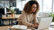© StockSphere - Busy young professional business woman employee or student wearing glasses using laptop watching online webinar or training web course, looking at computer, thinking, doing research working in office.