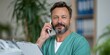 © Andrii Zastrozhnov - Male medical professional speaking on phone in clinic
