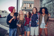 © Marko Geber - Group of young friends laughing together on city street