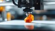 © aulaiphon - 3d printing process of an orange object in a workshop environment focused technology demonstration with close-up viewpoint