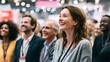 © Oleh - Diverse group of business people, including a smiling woman in the foreground, attending a professional conference or event, actively engaging and finding amusement in the presentation