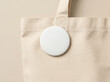 © Painted Storyline - White Blank Round Pin Badge Button Mockup on Natural Canvas Tote Bag Beige Background for Design