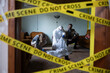 © Dejan - Forensic specialist and detectives examining evidence at a cordoned-off crime scene, investigating a serious criminal case