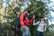 © Chanakon - Couple Hiker man and woman climbing rocky mountain to explore cave hill and river enjoying outdoor adventure trekking, and nature travel. Two traveller and nature lover on an exciting hiking journey