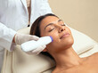 © Muhammad Asad - Dermatologist performing cosmetic laser lifting and collagen boost therapy on patient in modern dermatology center