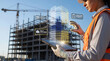 © Eduardo Accorinti - Female civil engineer using AI holographic BIM interface with virtual 3D building model for project management, structural integrity analysis and safety compliance at construction site