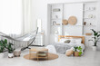 © New Africa - Comfortable hammock, bed and houseplants in room. Interior design