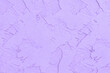 © mod - A soft lavender stucco wall shows a rough and cracked textured surface.