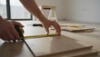 © antuanetto - Man measuring laminate plank for flooring installation during a home renovation project for home improvement concept with bright natural lighting