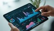 © Trendy stock for you - Close-up of hands holding a tablet displaying financial charts and data analytics a finger pointing to a specific data point on a graph stock market business technology