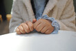 © Towfiqu Barbhuiya  - Child sits at table with hands clasped in waiting posture