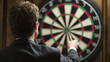 © Lemonkey - Businessman aiming a dart at a dartboard, representing focus, strategy, and achieving goals.