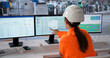 © Andrey Popov - Woman Monitors Production Schedules On Multiple Screens