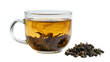 © Finn - Clear glass mug filled with amber tea and steeped leaves dry leaves beside it, isolated on transparent background