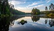 © EBG Stock Studio - Lago tranquilo rodeado de bosque con reflejos perfectos y cielo azul sereno