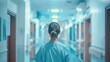 © svastix - A nurse walks down a hospital corridor, embodying resilience and dedication, especially during night shifts. The lighting adds a somber but hopeful atmosphere to the scene.
