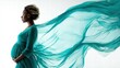 © MarkelovaVision - Elegant pregnant woman in a teal dress, with flowing fabric, set against a white background