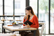 © David - Asian woman student studying online at cafe