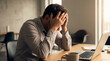 © @Amorea10 - Stressed businessman holding head at laptop in office. Burnout, work overload, mental fatigue, headache