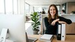 © Ada - Portrait of a smiling young professional businesswoman leaning on office binders at her modern desk, blank copy space