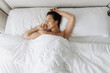 © wedmoments.stock - Woman staying in bed longer after waking up, enjoying warmth and quiet time alone. Concept self-care morning and slow lifestyle.