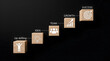 © Stock - Wooden stairs cubes representing path to success with upskilling idea team and growth icons on black background.