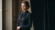 © Arra Vais - Thoughtful woman in black mourning dress by window. Elegant black mourning dress features high collar, long sleeves, conveying somber respect. Classic black mourning dress for funeral, memorial.
