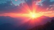 © Viktor - Sunrise over misty mountains. Sunbeams break through clouds casting pink orange light across landscape. Distant peaks layered in haze. New day begins.
