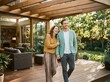 © utaem2022 - Happy couple laughing together on wooden deck surrounded by lush greenery