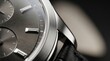 © Rommy - Close up of a luxury mechanical wristwatch featuring a dark grey dial with polished silver indices and leather strap details