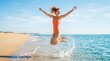 © velikiyzayats - Happy young woman in orange swimsuit jumping for joy in ocean surf on sunny beach