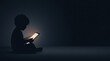 © Anat art - A child sits quietly on the floor, focused on a tablet screen, surrounded by darkness in the evening.