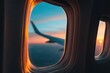 © oksa_studio - Airplane window showing a vibrant sunset sky and aircraft wing, capturing the beauty of travel and flight at golden hour