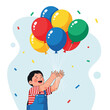 © Zoro - A boy excitedly reaching for colorful balloons