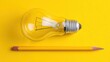 © hai - Creative idea light bulb and sharpened pencil on vibrant yellow background, symbolism of innovation.